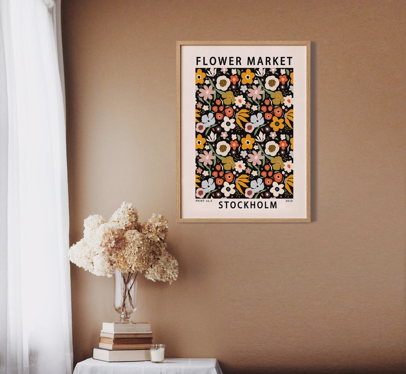 May include: A poster with a floral pattern in shades of orange, yellow, pink, and green on a black background. The poster has the text "FLOWER MARKET STOCKHOLM" at the top and bottom.