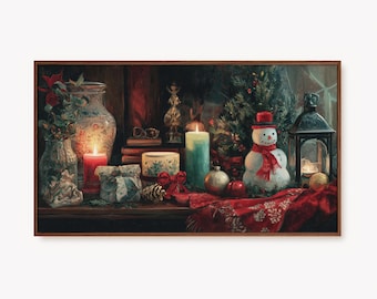 May include: A framed painting depicts a festive Christmas scene. A snowman with a red scarf and hat sits near a small Christmas tree. Lit candles, a lantern, and wrapped gifts are also visible, along with a red patterned cloth.