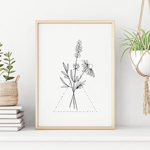 May include: A black and white line drawing of a bouquet of flowers in a triangle frame. The flowers include a daisy and lavender. The drawing is on a white background and framed in a light wood frame.