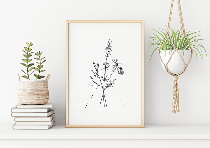 May include: A black and white line drawing of a bouquet of flowers in a triangle frame. The flowers include a daisy and lavender. The drawing is on a white background and framed in a light wood frame.