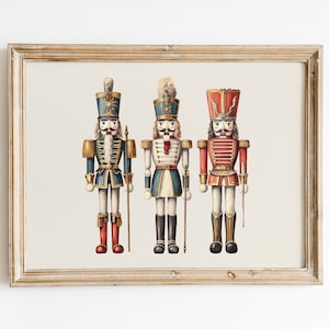 May include: Three vintage-style nutcracker figurines in a wooden frame. The nutcrackers are dressed in red, blue, and white uniforms with gold accents. They are holding a spear and a staff.