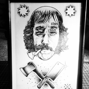 May include: Black and white illustration of a man with a beard and a pipe. He has three eyes and the word "Butcher" written across his forehead. The image also includes an axe and a cleaver crossed over each other, a compass, and two stars.