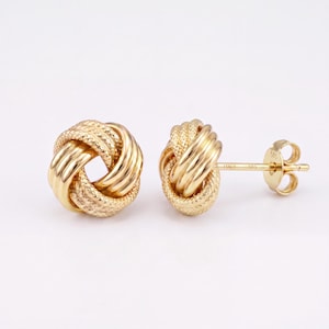 May include: A pair of 14ct yellow gold stud earrings featuring a textured love knot design. Each earring consists of intertwined polished and diamond-cut gold strands forming a spherical knot shape, complete with a post back and a 585 stamp.