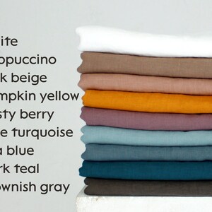 May include: A stack of folded fabric in various colors, including white, cappuccino, pink beige, pumpkin yellow, dusty berry, pale turquoise, sea blue, dark teal, and brownish gray. The image also includes a list of the colors.