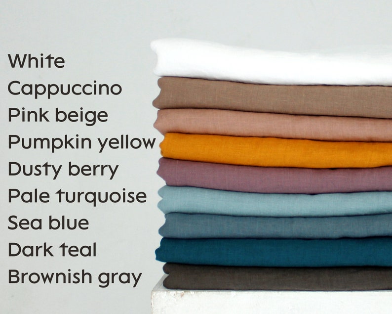 May include: A stack of folded fabric in various colors, including white, cappuccino, pink beige, pumpkin yellow, dusty berry, pale turquoise, sea blue, dark teal, and brownish gray. The image also includes a list of the colors.