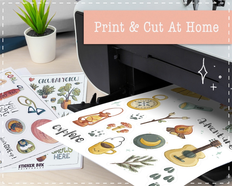 May include: A white sheet of paper with colorful stickers printed on it. The stickers feature camping and adventure themed illustrations, including a compass, a campfire, a guitar, and a mug of coffee. The paper is being fed into a printer with the text "Print & Cut At Home" on the front.