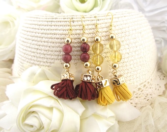 May include: Four pairs of dangle earrings with gold-colored hooks and accents. Each earring features a different combination of beads and a tassel. The tassels are burgundy and yellow. The beads are burgundy and yellow.