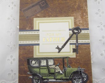 May include: A rectangular greeting card with a wood grain background featuring a vintage green automobile, two dark metal keys, and a rectangular label with the gold text FOR MY FATHER. A small rectangular stamp graphic with the text GASOLINE OIL 50 CENT is in the corner.