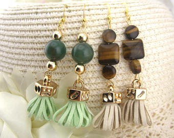 May include: Four pairs of dangle earrings with gold-colored hooks and accents. Two pairs feature green beads and tassels, while the other two have brown and tan beads and tassels. The tassels are in light green and beige.