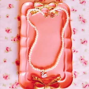 Pink swan & white pearls necklace.