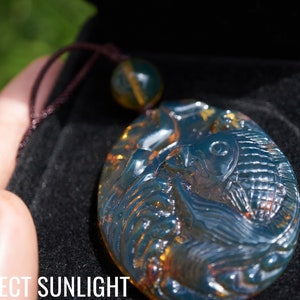 Blue Amber Dominican Koi fish hand carved pale Blue Amber Pendant with small amber bead adjustable rope koi fish pale blue amber