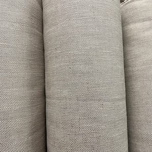 May include: Three rolls of gray fabric with a herringbone pattern.