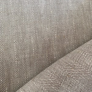 May include: Brown and white herringbone fabric with a subtle texture. The fabric is folded in half, showing the pattern on both sides.