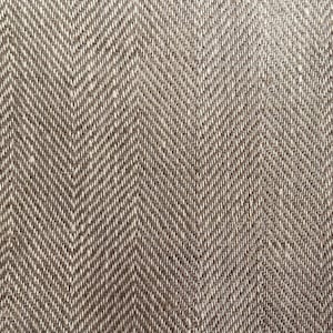 May include: Close-up of a brown and white herringbone fabric with a subtle texture.