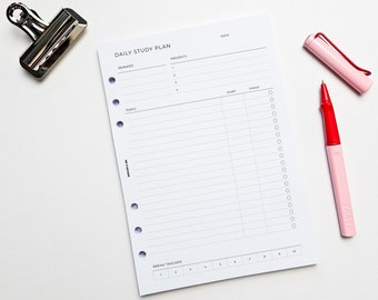 May include: A white daily study plan page with a black header that reads "Daily Study Plan". The page has sections for "Reward", "Topic", "Priority", "Start", "Finish", and "Break Tracker".