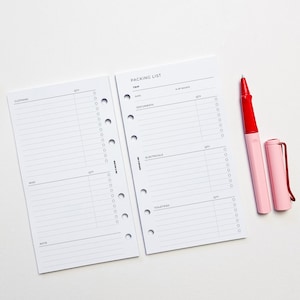 May include: A white packing list with sections for clothing, misc, notes, documents, electricals, and toiletries. The list has columns for quantity and check boxes. The list is on a white background with a red and pink pen.