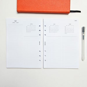 a notepad, pen, and a notebook on a table
