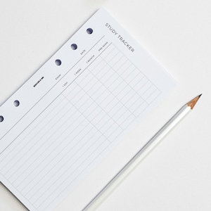 May include: A white study tracker with a grid layout and headings for "Date", "Exam", "1 Day", "1 Week", "1 Month", and "Pre Exam". The tracker is designed for a disc-bound planner.