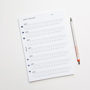 a calendar with a pen on top of it