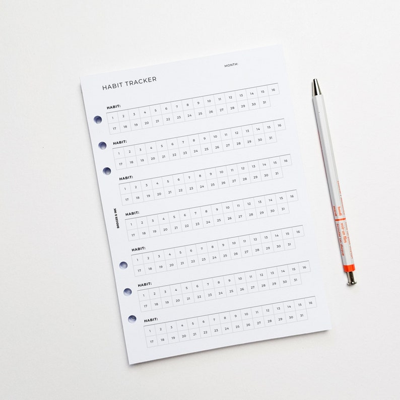 a calendar with a pen on top of it