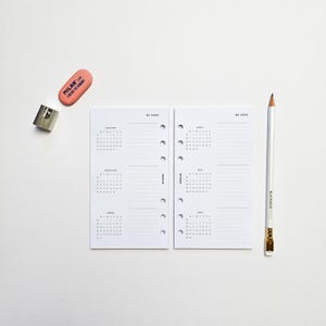 May include: Two white pages with monthly calendar layouts for the first and second quarters of 2023. The pages are designed for a personal planner or journal. The pages are laid out with a grid of dates and lines for writing notes. The pages are labeled "Q1 2023" and "Q2 2023".