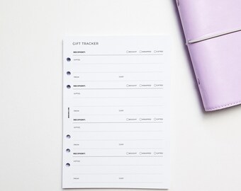 May include: A white gift tracker with a black heading "GIFT TRACKER". The tracker has four sections for recording recipient, gift, cost, and whether the gift has been bought, wrapped, and gifted. The tracker is designed for a disc bound planner.