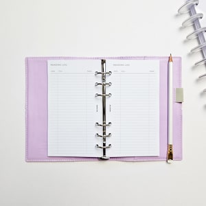 a notebook with a notepad and a pen on top of it