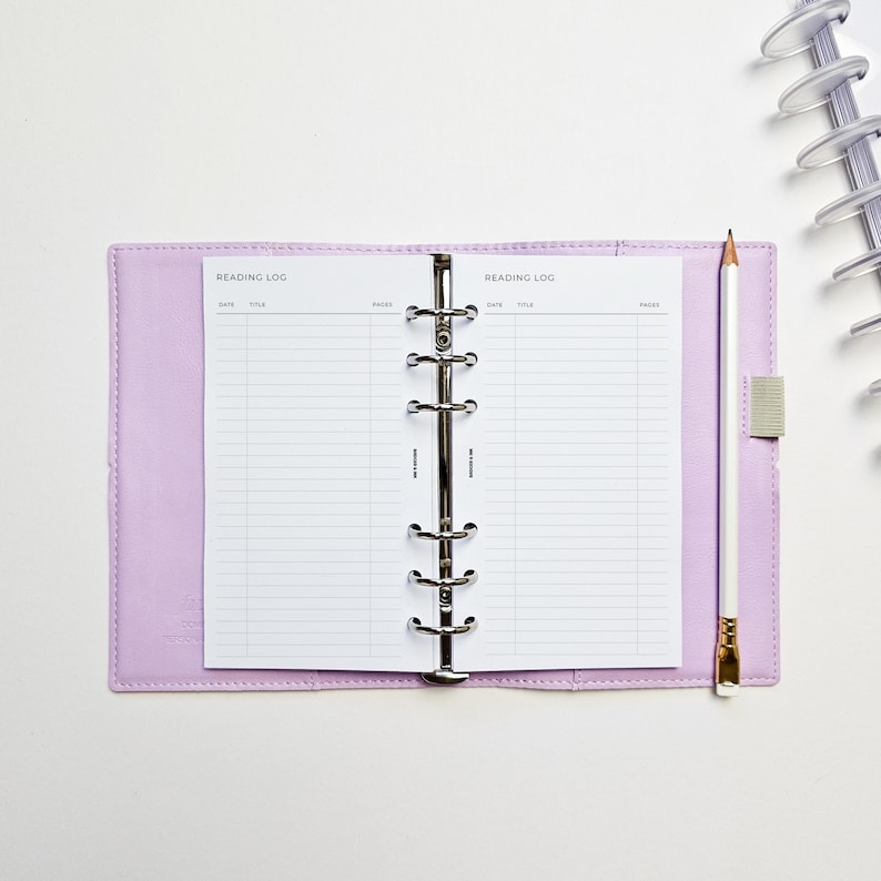 a notebook with a notepad and a pen on top of it