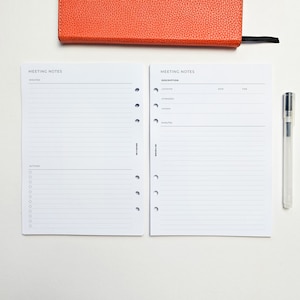 May include: Two blank white pages with the text "Meeting Notes" at the top. The left page has the heading "Minutes" and "Actions". The right page has the headings "Description", "Location", "Attendees", "Agenda", "Minutes".