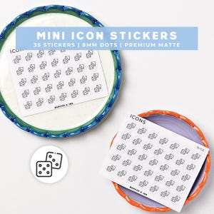 May include: Two sheets of mini icon stickers featuring black line art of dice on white circular backgrounds. Each sheet contains 35 stickers measuring 8mm in diameter. The text on the sheets reads MINI ICON STICKERS, ICONS, DICE, and BADGER & INK.