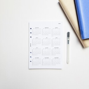 a desk with a notebook and a pen