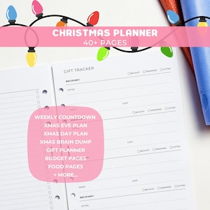 May include: A white Christmas planner with a pink banner reading "CHRISTMAS PLANNER 40+ PAGES". The planner includes sections for gift tracking, weekly countdown, and budget pages. Decorative string lights are at the top.
