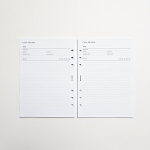 two blank film review forms with lined pages, placed side by side on a white background.