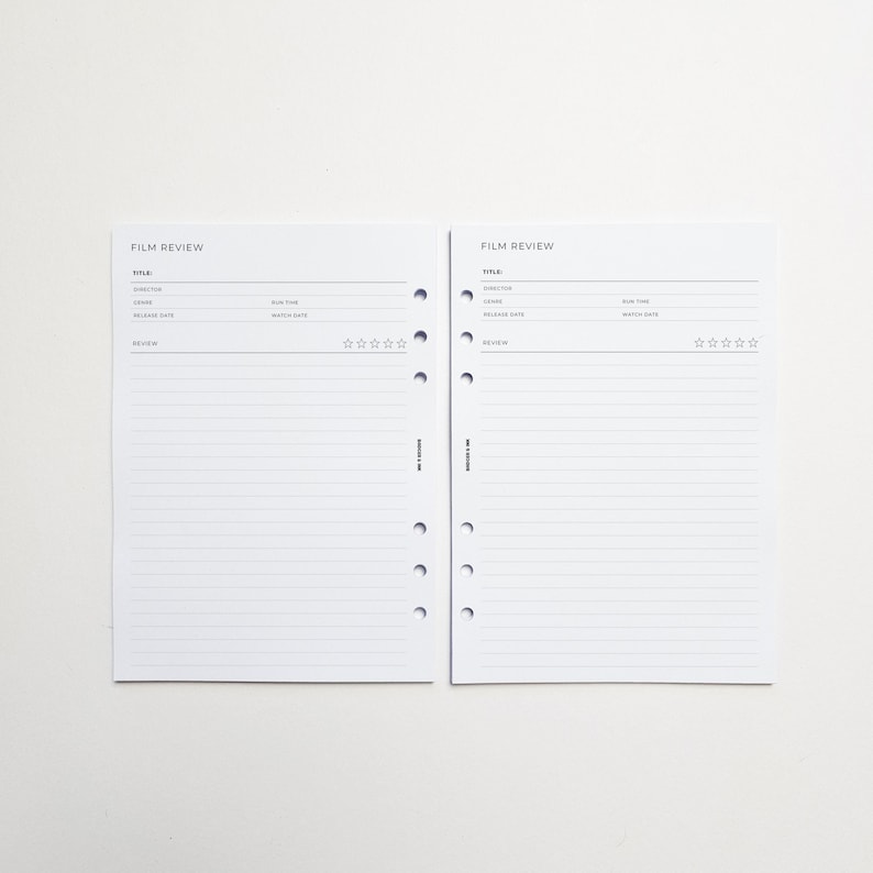 two blank film review forms with lined pages, placed side by side on a white background.