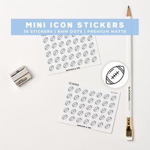 May include: White background with a pencil, sticker sheets, and a pencil sharpener. The sticker sheets have a grid of black and white football icons. The text on the sticker sheet says "ICONS" and "BADGER & INK". The text on the blue banner says "MINI ICON STICKERS".