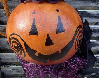 Halloween Gourd Jack O Lantern Hand Painted and Decorated on a bed spring Purple
