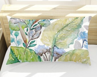 May include: Two white pillowcases with a watercolor floral design featuring green leaves, blue flowers, and yellow accents.