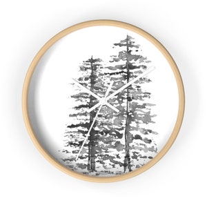 May include: A black and white watercolor painting of three trees on a white background. The painting is framed in a natural wood frame and is suitable for a wall clock.