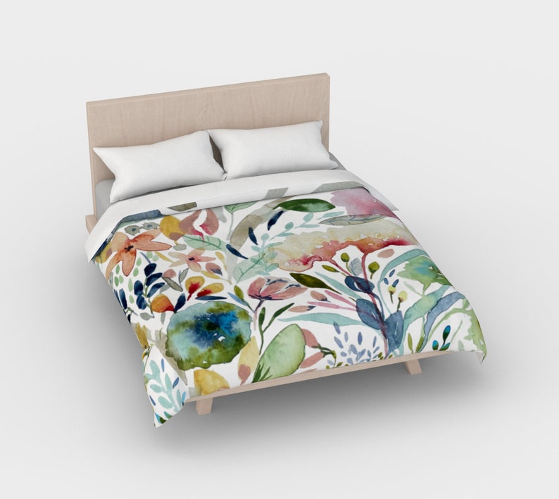 May include: A white duvet cover with a floral pattern featuring watercolor-style flowers in shades of pink, blue, green, yellow, and orange.