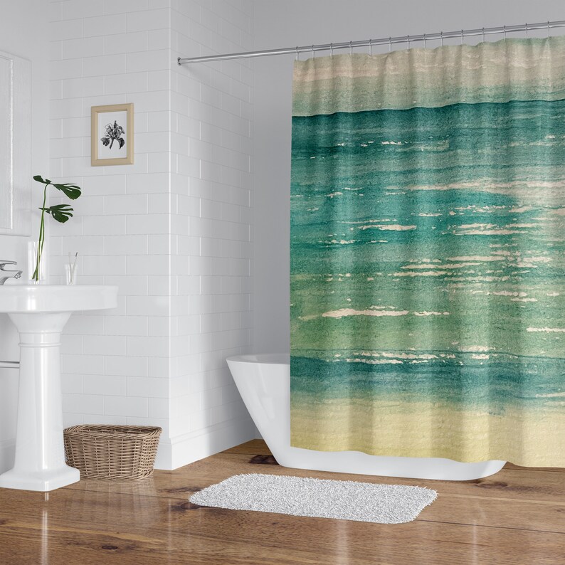 May include: A watercolor-style shower curtain featuring a blue and green ocean scene with a yellow sandy beach at the bottom.