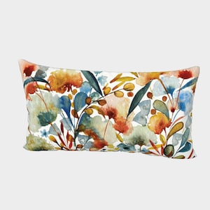 May include: A rectangular throw pillow with a watercolor floral pattern. The design features a variety of flowers and leaves in shades of blue, green, orange, and yellow on a white background.