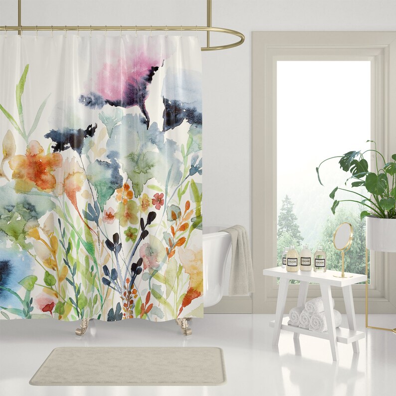 May include: A watercolor shower curtain featuring a floral design with blue, green, orange, and pink flowers on a white background.