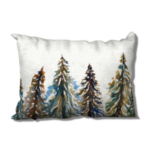 May include: A white throw pillow with a watercolor painting of a row of five pine trees in shades of brown, green, and blue.