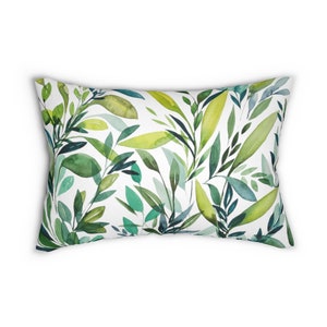 May include: A white rectangular pillow with a green and blue watercolor leaf pattern.