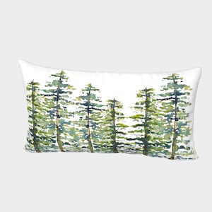 May include: A white rectangular pillow with a watercolor painting of a row of green pine trees. The trees are painted in shades of green, blue, and yellow.