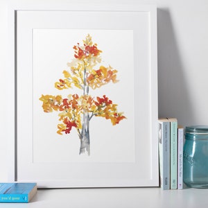 Op de afbeelding: Een aquarel van een boom met gele, oranje en rode bladeren. De boom is in een minimalistische stijl geschilderd op een witte achtergrond.