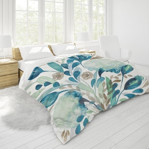 May include: A white duvet cover with a watercolor floral pattern in shades of blue, green, and brown. The duvet cover features a variety of flowers and leaves, creating a soft and romantic look.