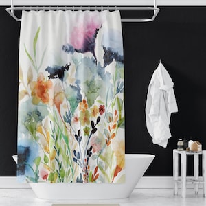 May include: A watercolor shower curtain featuring a floral design with blue, green, orange, and pink flowers on a white background.