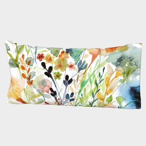 May include: A watercolour pillow cover featuring a colourful floral design with shades of blue, green, yellow, orange, and red. The flowers are abstract and stylised, creating a modern and artistic look.
