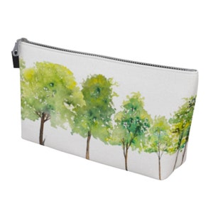 May include: White zippered pouch with a watercolor design of a row of green trees.